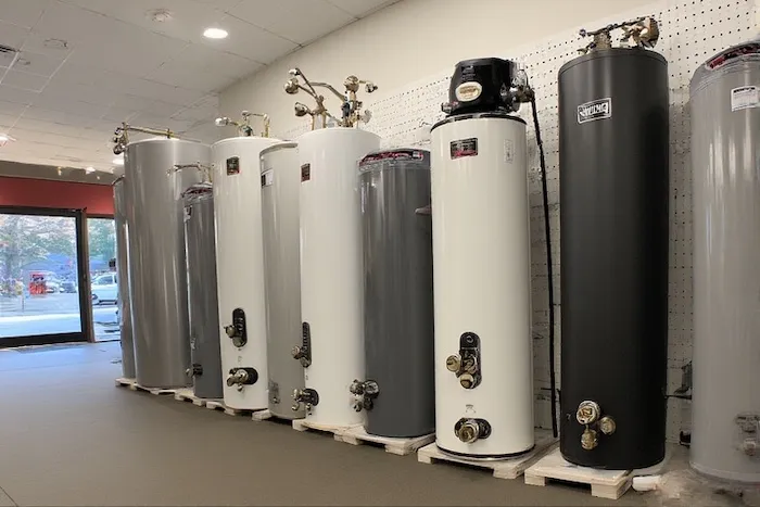 Various types of new water heaters on display in a store showroom