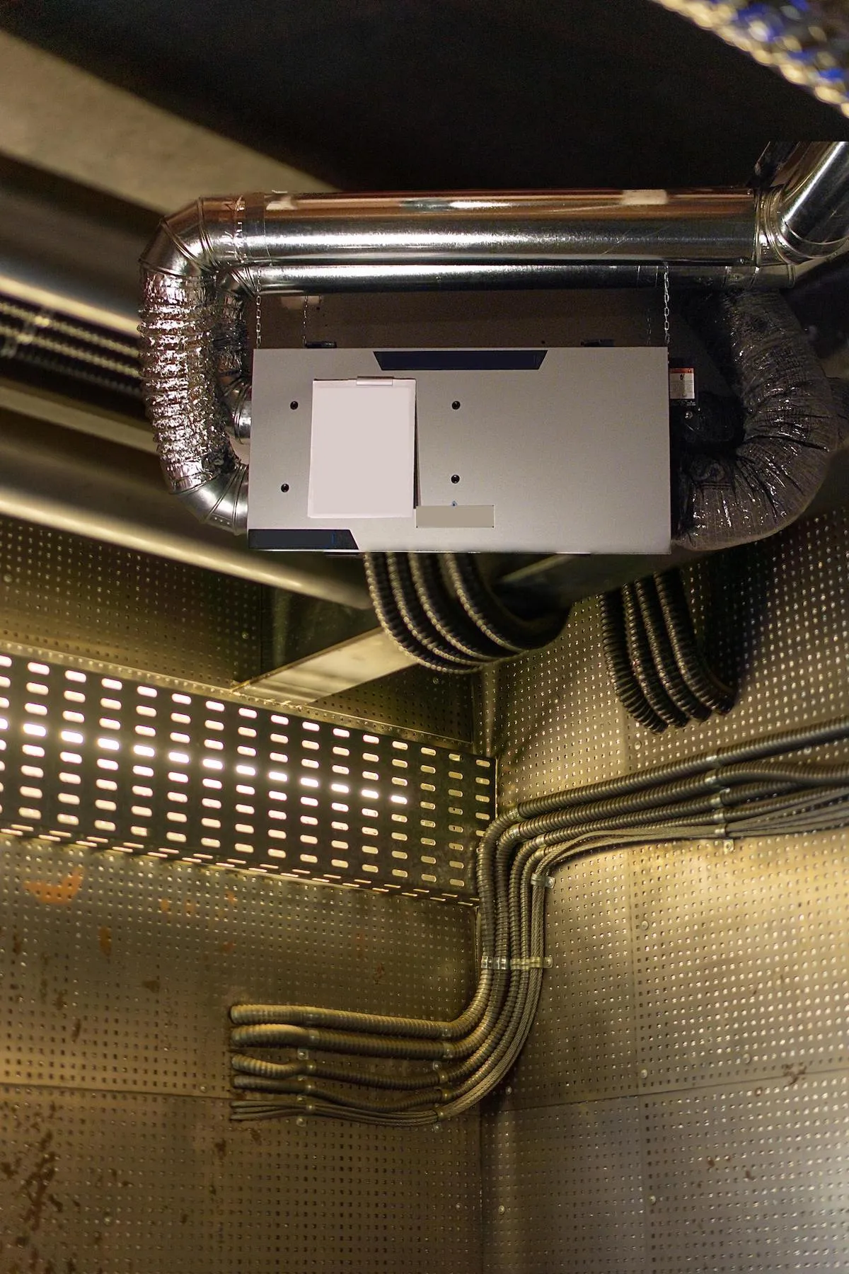 Modern Heat Recovery Ventilator (HRV) unit installed in a residential mechanical room